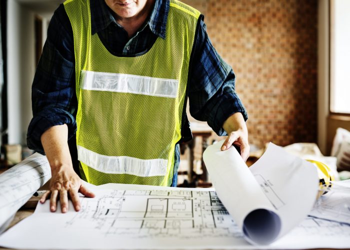 Architecture working on a blueprint Architecture working on a blueprint